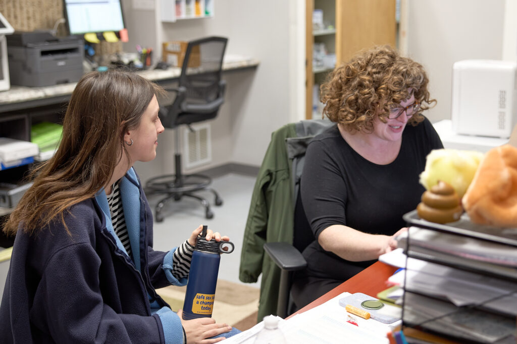 Health Plus Indiana staff member providing a sexual health and wellness consultation in a private office.